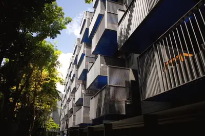 a building with balconies on the side of it at The Deck Condo Studios Patong w/ pool fitness in Patong Beach