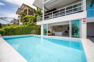 a swimming pool in front of a house at mona seaview pool villa beach front AoYon Beach in Panwa Beach
