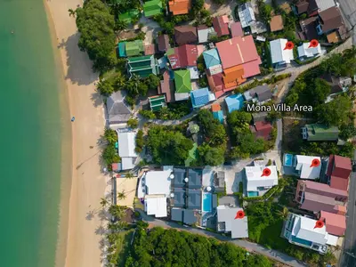 an aerial view of a village next to a beach at mona seaview pool villa beach front AoYon Beach in Panwa Beach