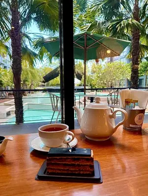 a tea set on a wooden table with a tea pot at Kamala Beach D68 Exclusive Junior Suite in Kamala Beach