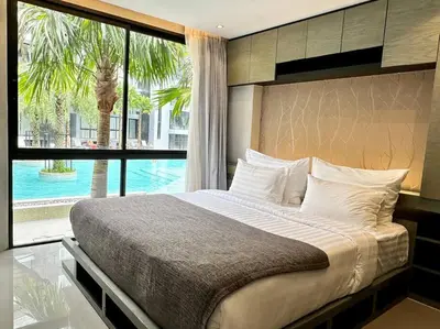 a bedroom with a large bed and a large window at Kamala Beach P15 Pool view Suite in Kamala Beach