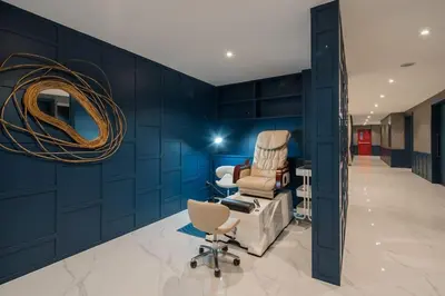 a salon with blue walls and a chair and a mirror at Kamala Beach P15 Pool view Suite in Kamala Beach
