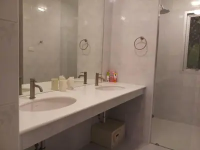 a bathroom with two sinks and a shower at Villa B23 Phuket in Nai Yang Beach