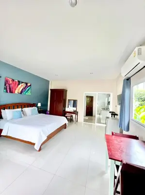 a large bedroom with a bed and a desk at Lay Back Villa C4 in Ban Nong Thale