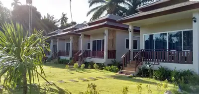 a house with a lawn in front of it at Lay Back Villa C4 in Ban Nong Thale