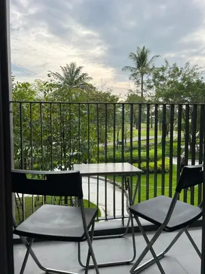 two chairs and a table on a balcony with a view at Skypark view golf Laguna Phuket in Bang Tao Beach