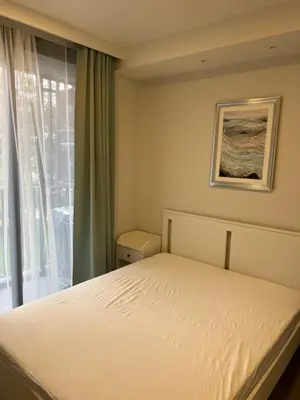 a bedroom with a bed and a window at Skypark view golf Laguna Phuket in Bang Tao Beach