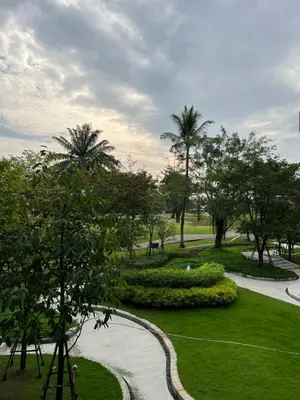 a park with palm trees and a walkway at Skypark view golf Laguna Phuket in Bang Tao Beach
