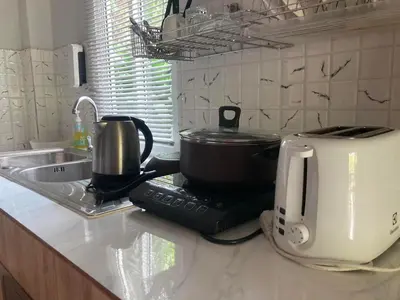 a kitchen counter with a coffee maker and a toaster at Lay Back Villa C1 with kitchen & High Speed Internet in Krabi town