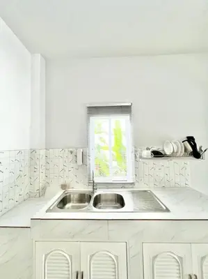 a white kitchen with a sink and a window at Lay Back Villa C1 with kitchen & High Speed Internet in Krabi town