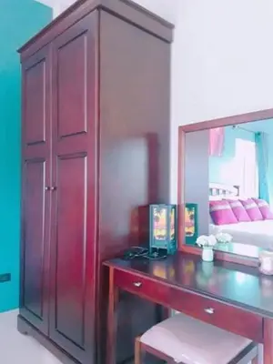 a bedroom with a desk with a mirror and a bed at Lay Back Villa C1 with kitchen & High Speed Internet in Krabi town