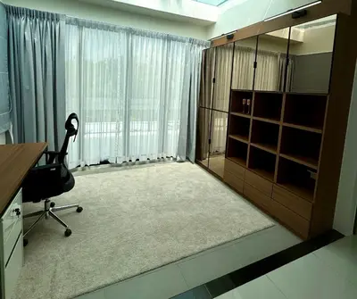 a room with a desk and a chair in front of a window at Laguna Park 2 in Phuket Town