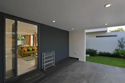 a living room with a yellow couch in a house at Laguna Park 2 in Phuket Town