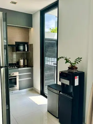a kitchen with a potted plant sitting on a stool at Laguna Park 2 in Phuket Town