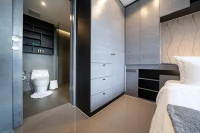 a small bathroom with a toilet and a bed at Tropics Kamala 2BR Apartment CTG B605-6 in Kamala Beach