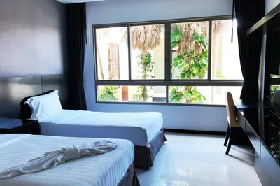 a hotel room with two beds and a window at Kamala Regent : Beautiful Modern Apartment close to Kamala beach in Kamala Beach