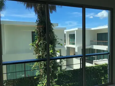 a view of a building through a window at Kamala Regent : Beautiful Modern Apartment close to Kamala beach in Kamala Beach