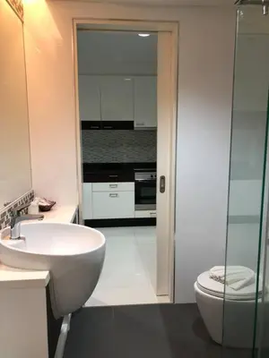 a white bathroom with a sink and a toilet at Kamala Regent : Beautiful Modern Apartment close to Kamala beach in Kamala Beach