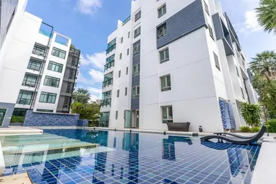 a swimming pool in front of a building at Kamala Regent : Beautiful Modern Apartment close to Kamala beach in Kamala Beach