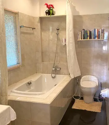a bathroom with a tub and a toilet at OASIS 4 or 5 bedroom VILLA in Karon Beach