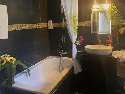 a bathroom with a tub and a sink at OASIS 4 or 5 bedroom VILLA in Karon Beach