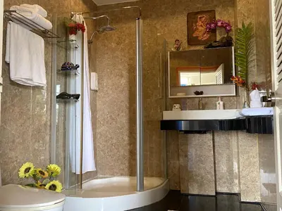 a bathroom with a shower and a toilet and a sink at OASIS 4 or 5 bedroom VILLA in Karon Beach