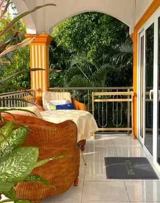 a porch with a couch and a balcony with trees at OASIS 4 or 5 bedroom VILLA in Karon Beach