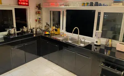 a kitchen with a sink and two windows at OASIS 4 or 5 bedroom VILLA in Karon Beach