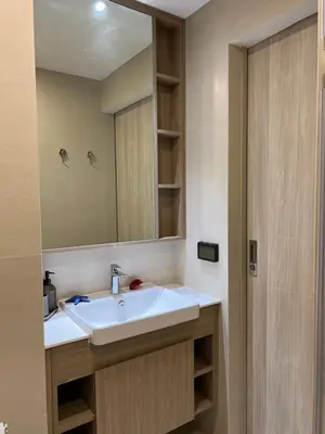 a bathroom with a sink and a mirror at SKYPARK Building A Laguna Phuket in Bang Tao Beach