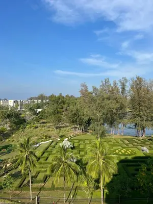 a view of a park with palm trees at SKYPARK Building A Laguna Phuket in Bang Tao Beach