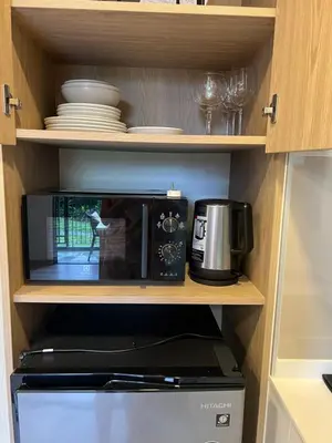 a microwave oven sitting inside of a kitchen at SKYPARK Building A Laguna Phuket in Bang Tao Beach
