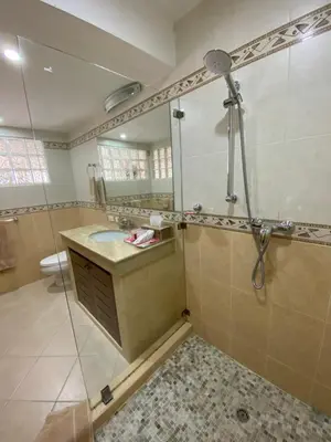 a bathroom with a shower and a sink and a mirror at Andaman Hill Pool Seaview in Patong Beach