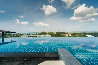 a swimming pool with blue tiles on the top of a building at Private apartment at Aristo Resort by Lofty in Surin Beach