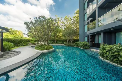 a swimming pool in front of a building at Private apartment at Aristo Resort by Lofty in Surin Beach