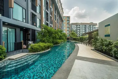 a swimming pool in the middle of a building at Private apartment at Aristo Resort by Lofty in Surin Beach