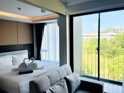 a bedroom with a bed and a large window at Private apartment at Aristo Resort by Lofty in Surin Beach