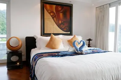 a bedroom with a bed with a heart decoration on it at Kata Ocean View Luxury condo & Seaview K12 in Kata Beach
