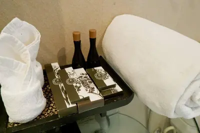 two bottles of wine on a table with towels at Kata Ocean View Luxury condo & Seaview K12 in Kata Beach