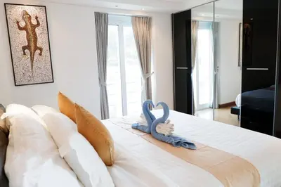 a bedroom with two swans decorations on a bed at Kata Ocean View Luxury condo & Seaview K12 in Kata Beach