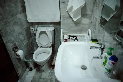a small bathroom with a toilet and a sink at 777 Beach Condo Phuket in Mai Khao Beach