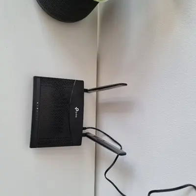 a black computer monitor hanging on a wall at 777 Beach Condo Phuket in Mai Khao Beach