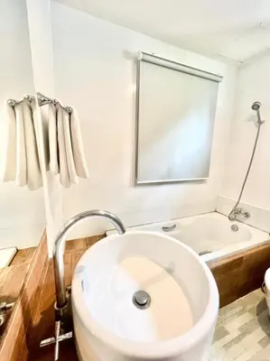 a white bathroom with a tub and a sink at Lay Back Villa C3 with Kitchen & High Speed Internet in Ban Laem Som