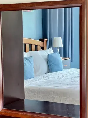 a mirror reflection of a bed in a bedroom at Lay Back Villa C3 with Kitchen & High Speed Internet in Ban Laem Som