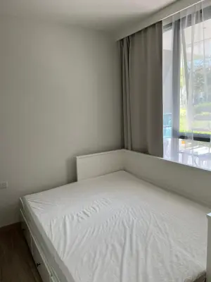 a white bed in a room with a window at SkyPark Laguna Phuket с террасой in Bang Tao Beach