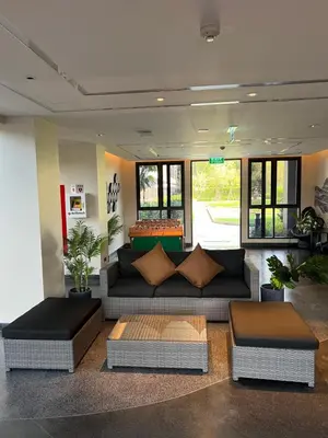 a living room with a couch and two tables at SkyPark Laguna Phuket с террасой in Bang Tao Beach