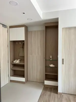 a dressing room with wooden doors and shelves at SkyPark Laguna Phuket с террасой in Bang Tao Beach