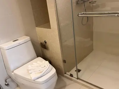 a bathroom with a toilet and a shower at Aristo O59 Junior Suite Surin Beach in Phuket Town