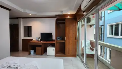 a bedroom with a desk and a computer in it at Chalita House in Patong Beach