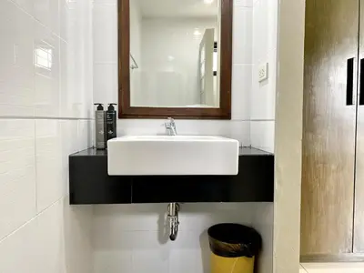 a bathroom with a white sink and a mirror at Mamatel boutique in Kamala Beach