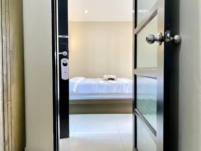 a door leading into a room with a bed at Mamatel boutique in Kamala Beach